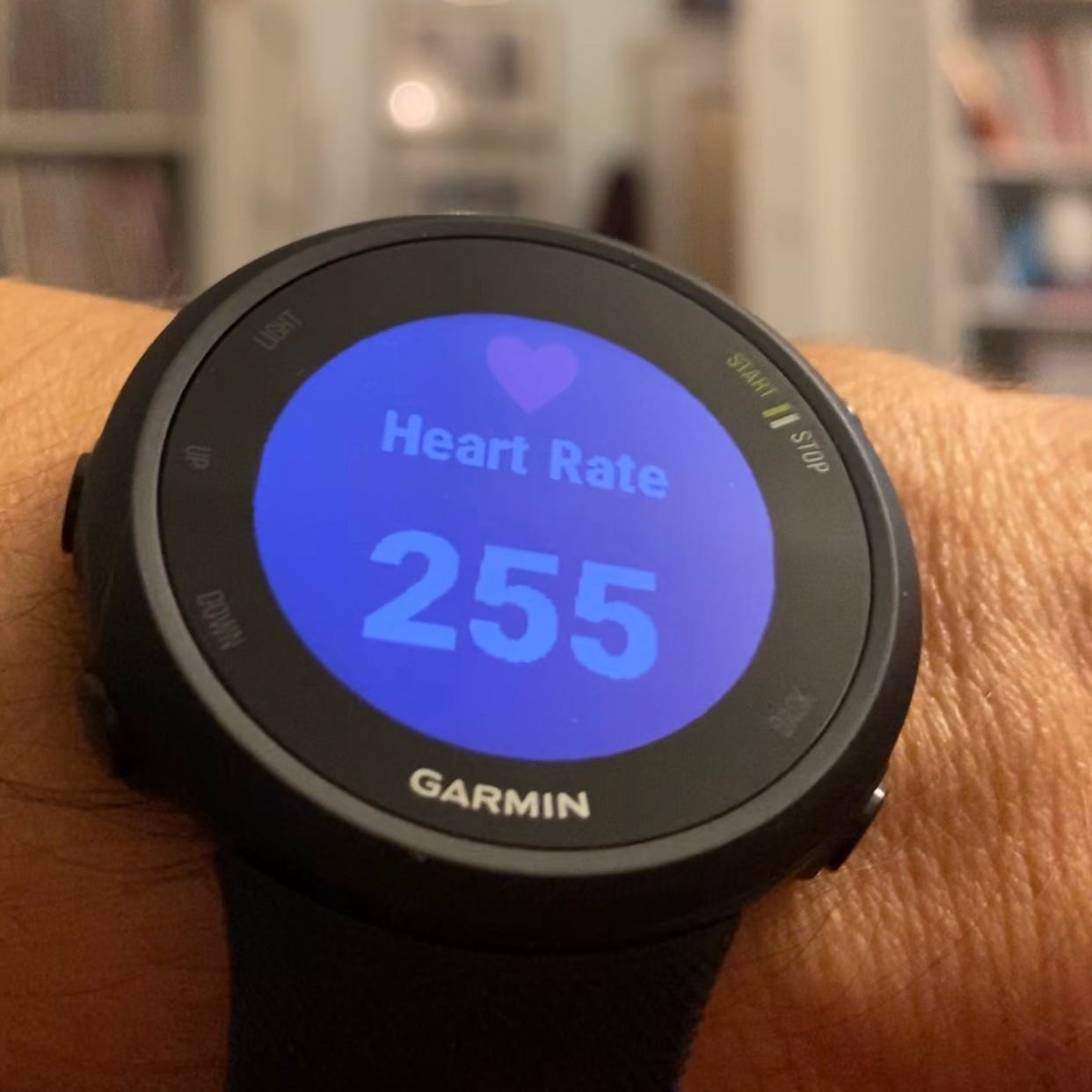 A person's wrist wearing a Garmin running watch